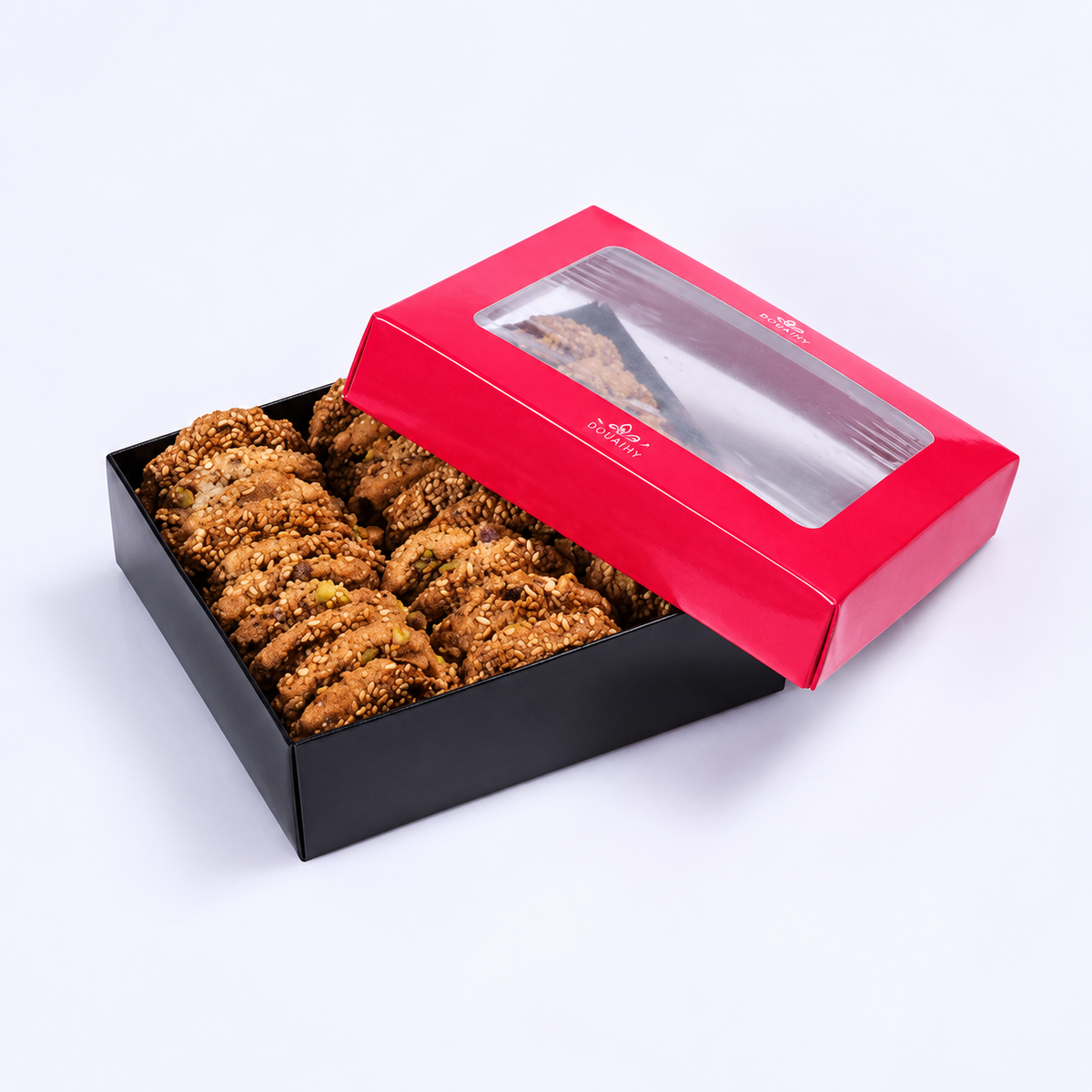 Douaihy Barazek ~ 30pcs. Sesame barazek cookies in a black gift box with pink windowed lid.