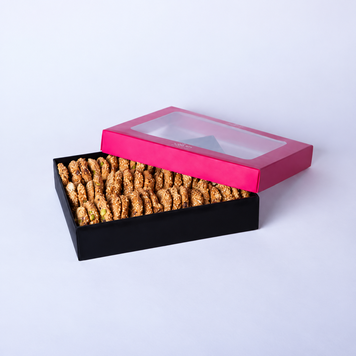 Douaihy Barazek ~ 60pcs. Rows of sesame barazek cookies in a black gift box with pink lid.