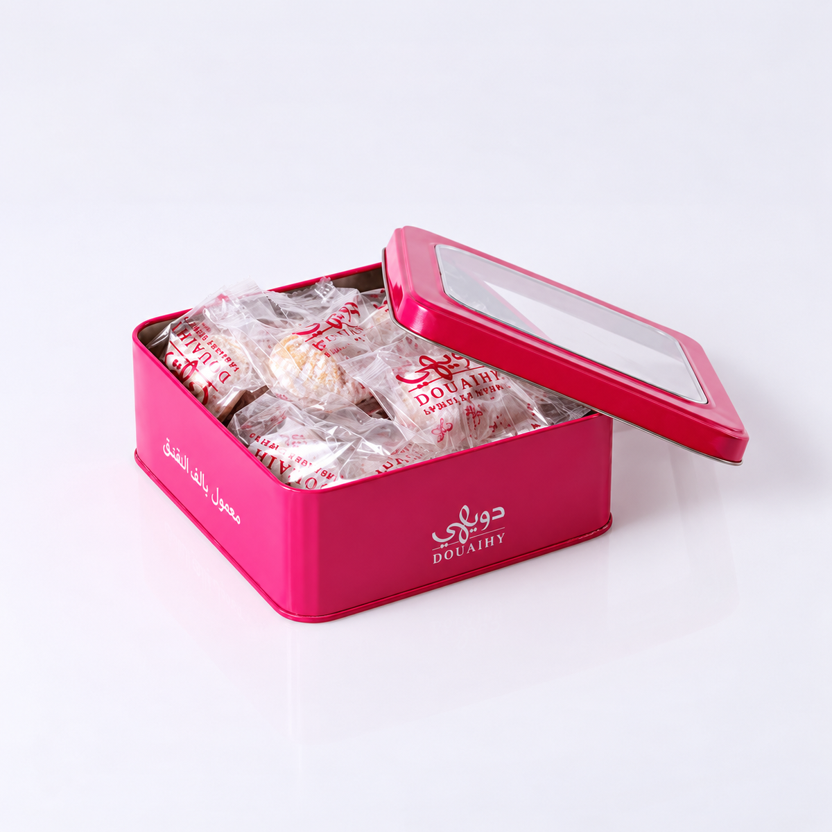 Douaihy Maamoul Pistachio Packed ~ 15pcs. Individually wrapped maamoul in an open pink tin with windowed lid.
