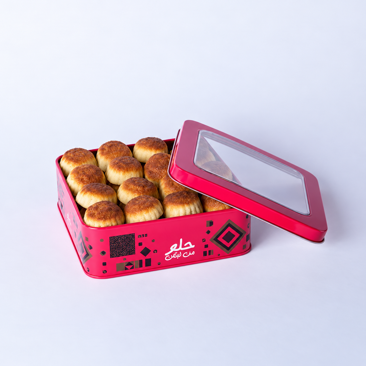 Douaihy Maamoul Dates ~ 30pcs. Golden date maamoul in an open pink windowed tin.