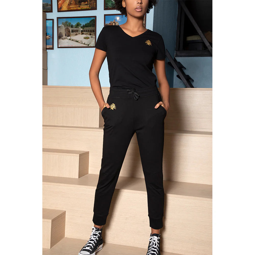 Black Lebanese sweatpants with gold cedar embroidery and cuffed hems for women