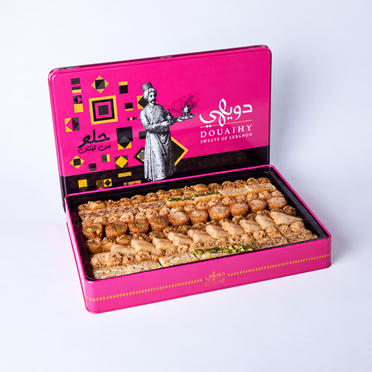 Douaihy Rectangular Tin Baklava ~ 105pcs. Assorted baklava in an open pink rectangular tin with illustrated lid.