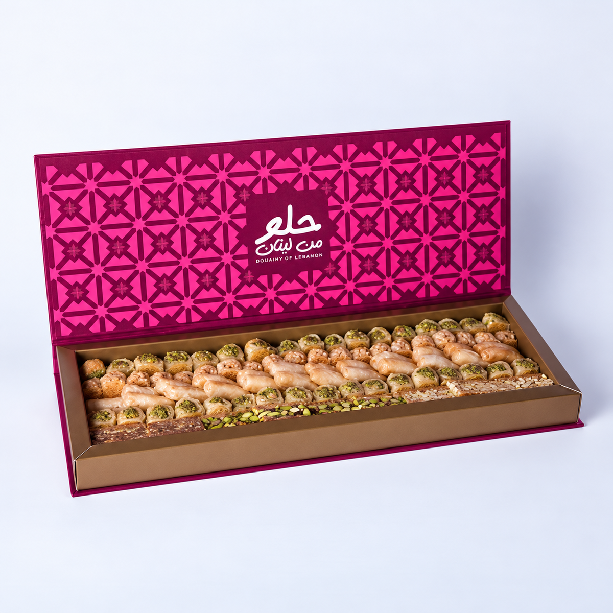 Douaihy Premium Book Rectangular ~ 75pcs. Assorted baklava in a rectangular book-style box with pink patterned lid.