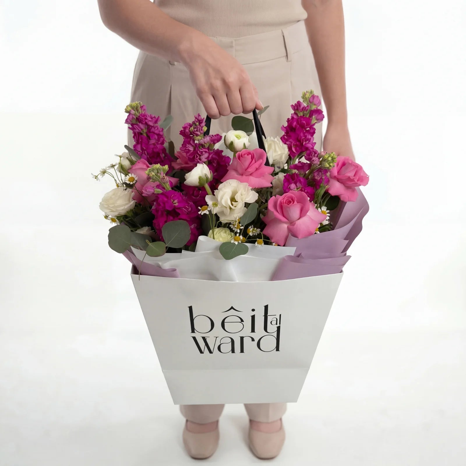 Colorful mixed flowers bouquet in white bag Lebanon by Beit El Ward