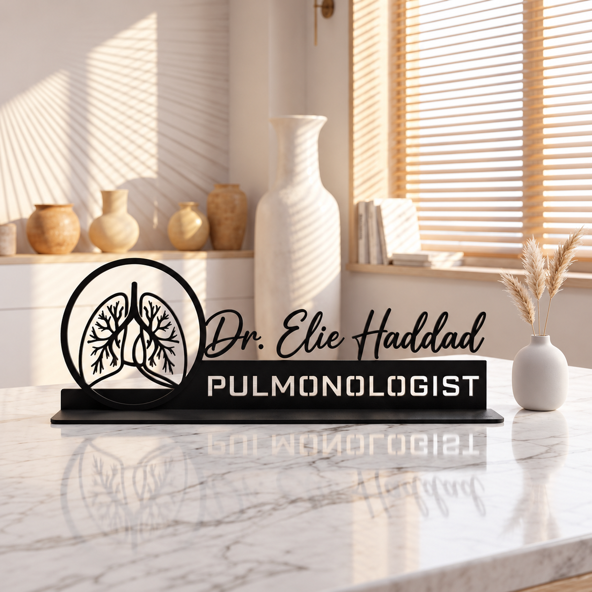Portret Lebanon Pulmonologist – The Signature Personalized Steel Desk Name Plate. Black steel personalized desk name plate with lung emblem and Dr. Elie Haddad lettering on a marble desk.