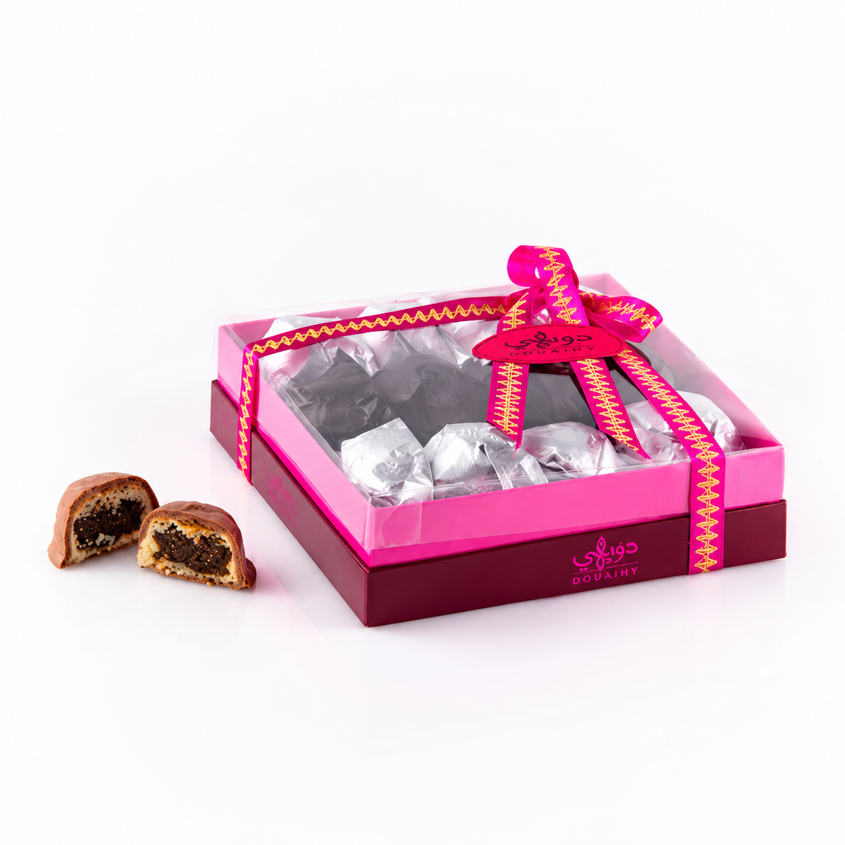 Douaihy Maamoul Chocolate ~ 15pcs. Wrapped chocolate maamoul in a pink ribbon gift box with cut pastry beside it.