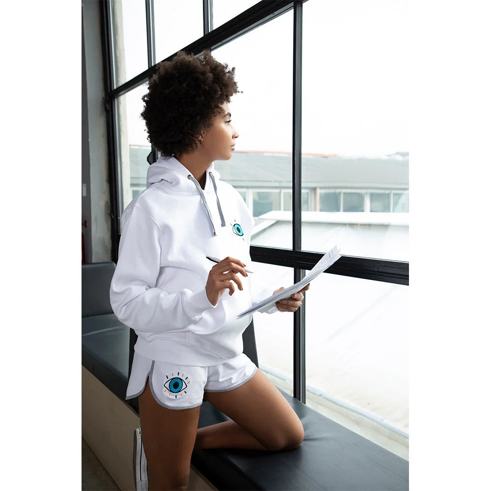 White women’s shorts with turquoise evil eye embroidery and side pockets