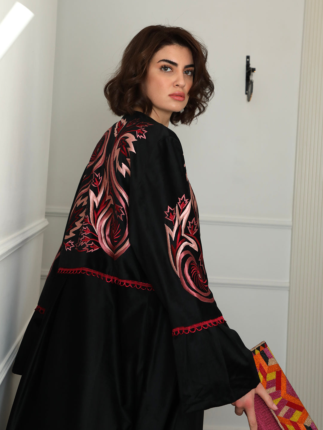 Black velvet abaya with red leafy swirl embroidery by Mouftah El Chark, elegant statement modest wear for women at Idole Lebanon