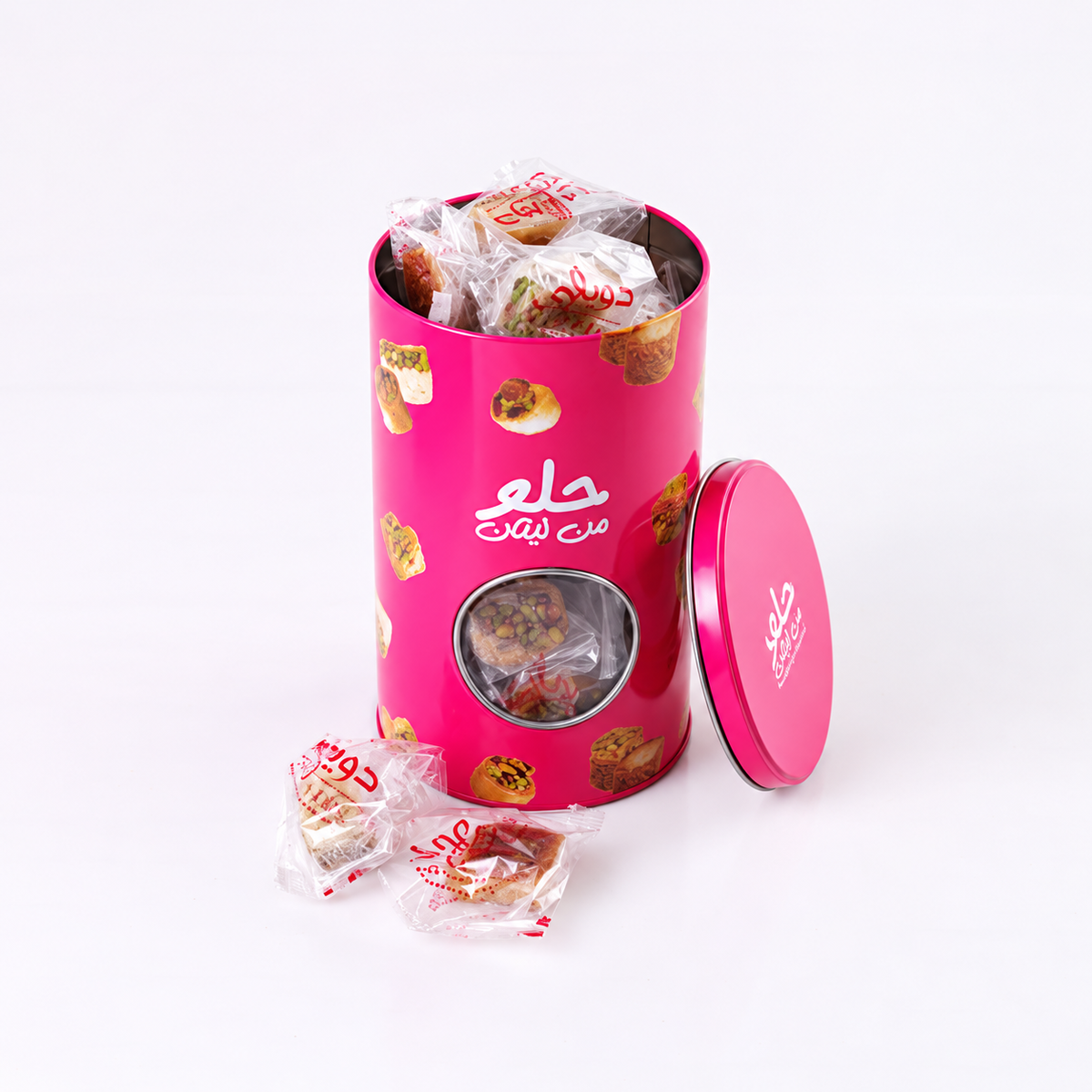 Douaihy Circular Tin Baklava Packed ~ 35pcs. Wrapped baklava in a tall pink cylindrical tin with round window.