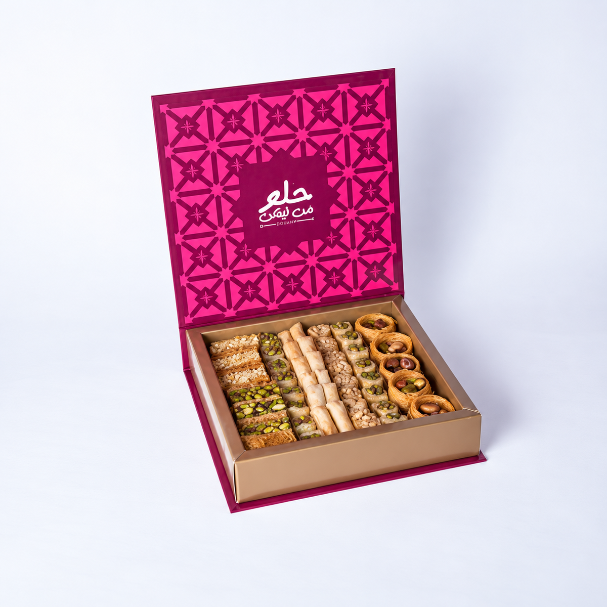 Douaihy Premium Book Gift Medium ~ 75pcs. Assorted baklava in an open book-style box with pink patterned lid.