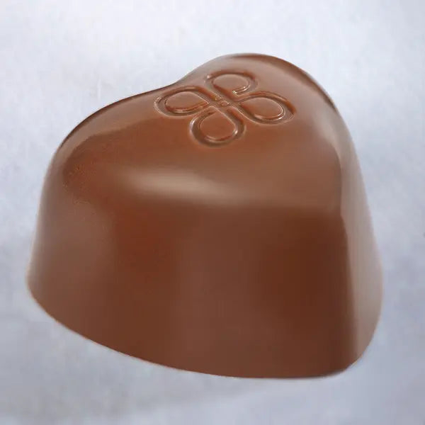 Open Coeur de Patchi gift tin showing heart-shaped chocolates