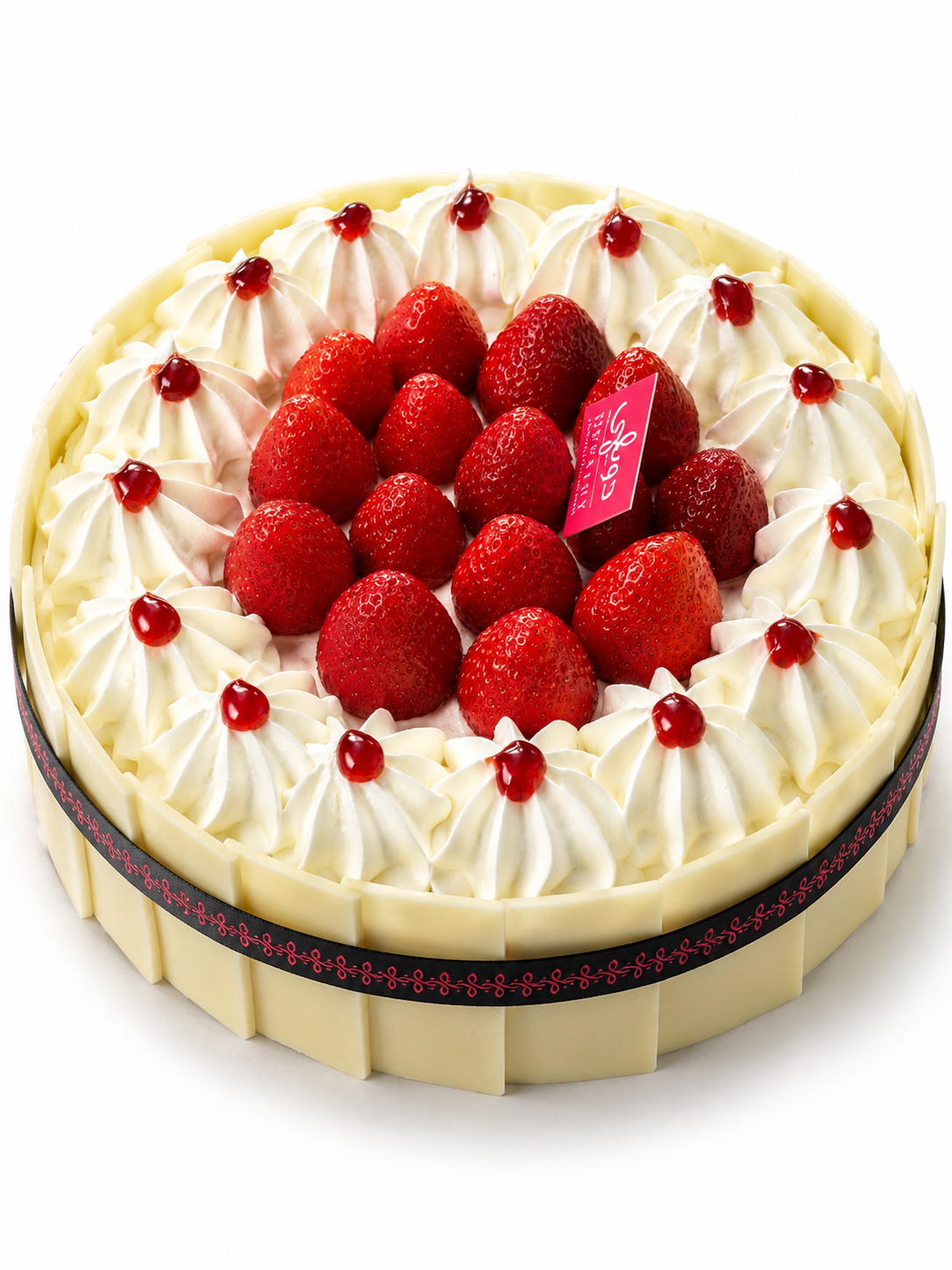 Strawberry Vanilla Cream Cake topped with fresh strawberries, whipped cream swirls, and white chocolate decoration.
