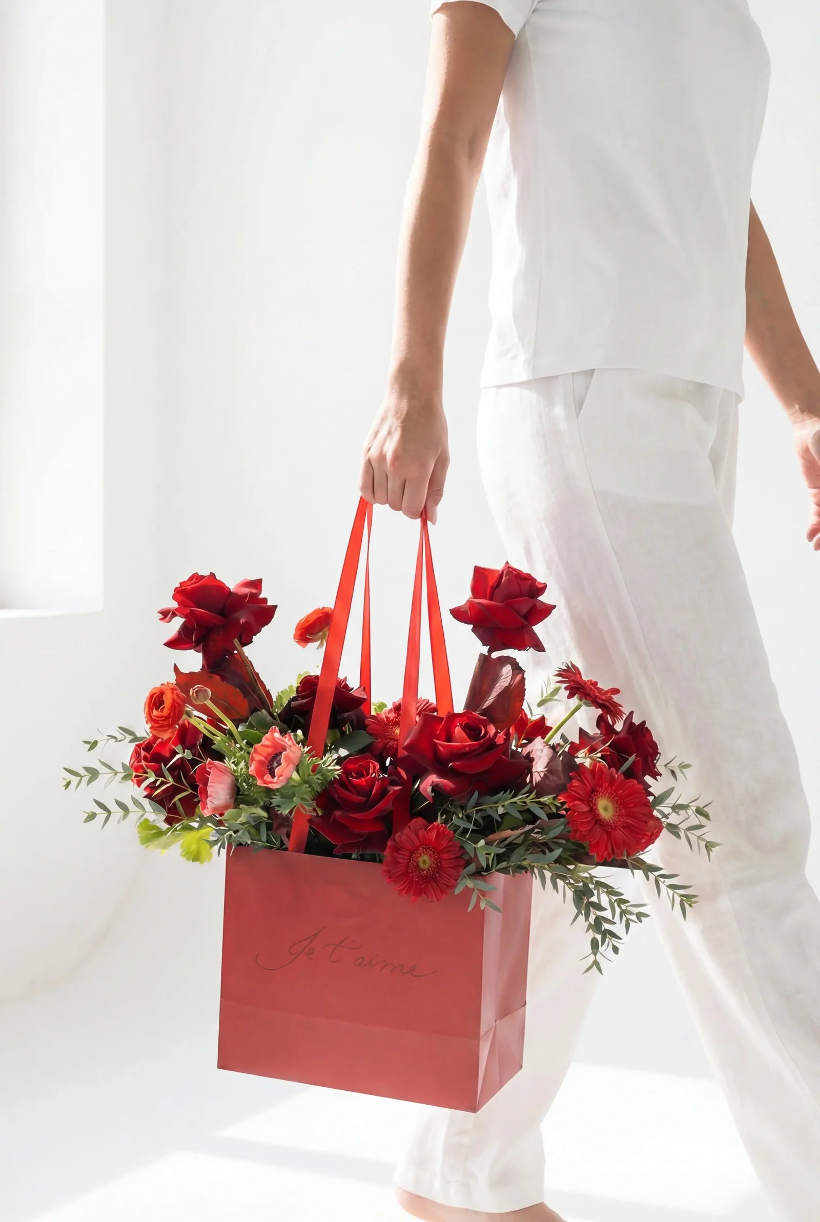 Red roses arrangement in a stylish bag by Beit El Ward Lebanon