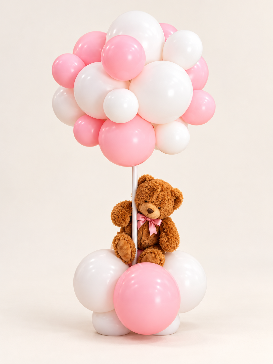 Blush Bear pink and white balloon arrangement with a brown plush teddy bear wearing a pink bow, on a clean off-white background