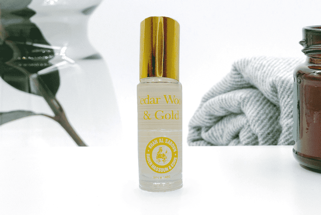 Cedar wood and pure gold body oil bottle by Khan Al Saboun with luxury skincare presentation in USA
