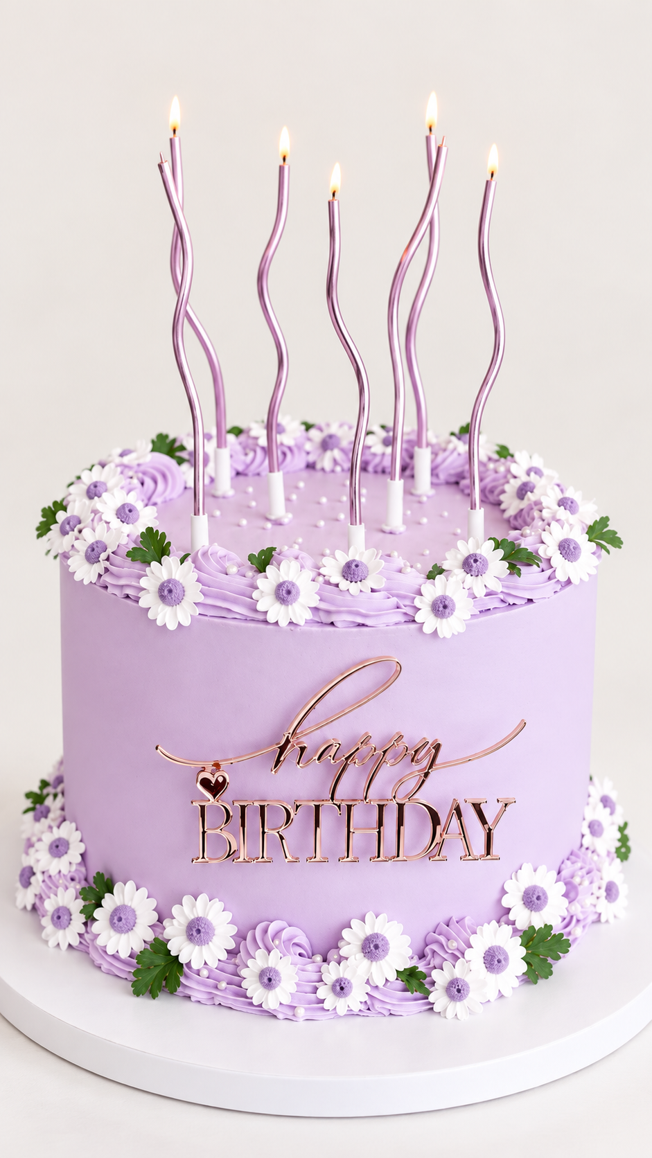Lavender daisy birthday cake with candles and Happy Birthday decoration