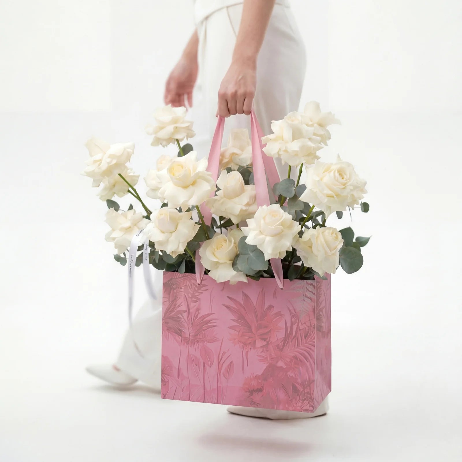 20 white roses arranged in pink bag with eucalyptus Lebanon by Beit El Ward