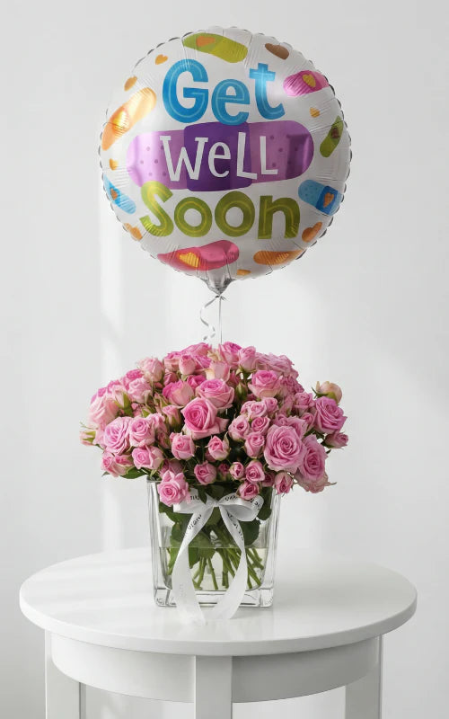 Pink roses in glass vase with get well soon balloon Lebanon by Beit El Ward