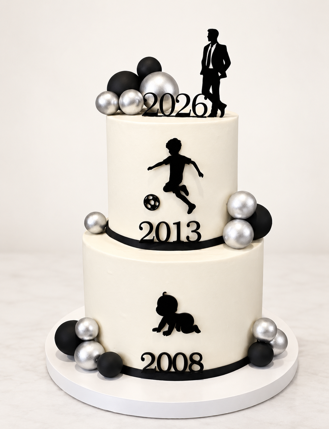 Three-tier life milestones cake in white with black and silver accents, silhouettes and years 2008, 2013, 2026