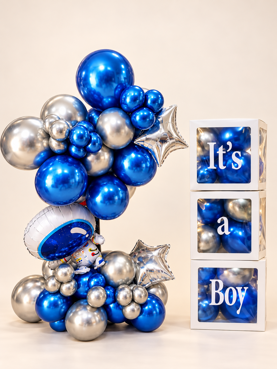 Little Astronaut metallic blue and silver balloon arrangement with astronaut and star foil balloons beside three filled white display boxes spelling It’s a Boy